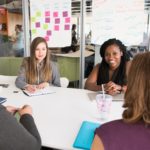 Women in a boardroom brainstorming
