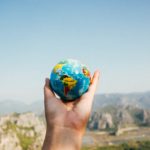 hands holding up a small globe